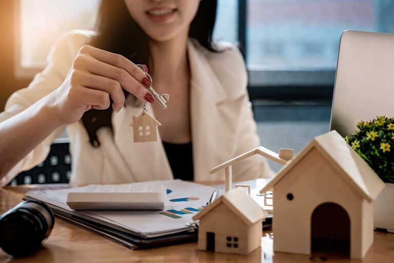 Homebuyers review a purchase offer and inspection notes at a kitchen table.